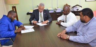 Prime Minister Gumbs signs for Middle Region sewage connections