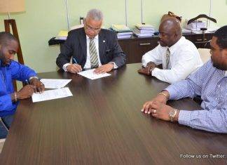 Prime Minister Gumbs signs for Middle Region sewage connections