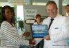 Minister of Tourism Arrindell, Port officials and Captain of Mein Schiff 3 Exchange Plaques on Inaugural Call