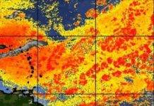 Partly Cloudy, HOT, and Hazy with slight chance of a brief shower