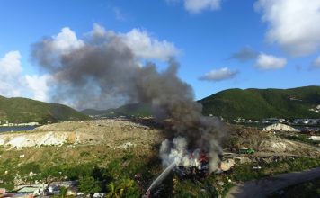 Tires on dump deliberately set on fire