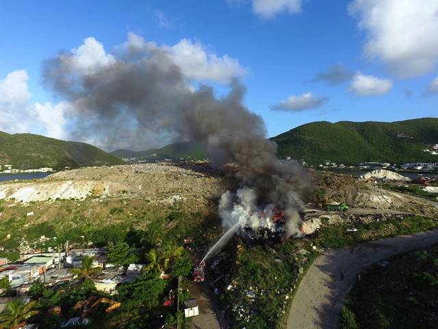 Tires on dump deliberately set on fire
