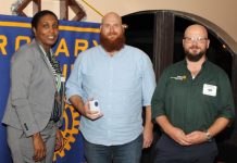 AUC hands over check for Haiti to Rotary Club