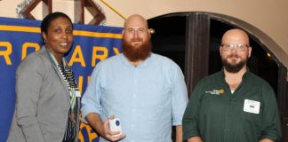 AUC hands over check for Haiti to Rotary Club