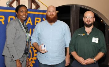 AUC hands over check for Haiti to Rotary Club