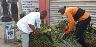 Minister of VROMI Christopher Emmanuel helps clean up Philipsburg area