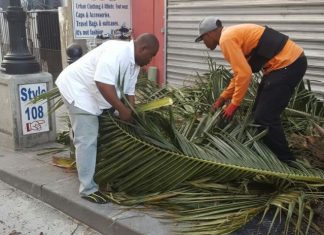 Minister of VROMI Christopher Emmanuel helps clean up Philipsburg area