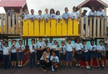 Miss Mature presents water bottles to students