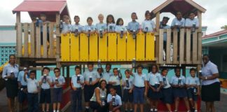 Miss Mature presents water bottles to students