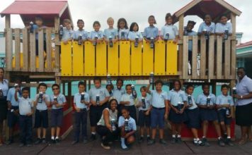 Miss Mature presents water bottles to students