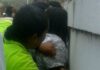 Police restrains mental patient.