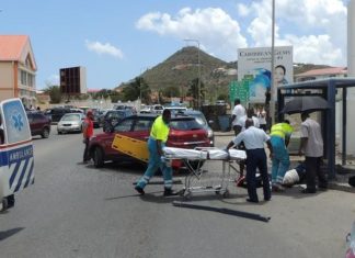 Lady struck by motor vehicle while sitting in the bus stop.