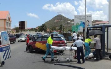 Lady struck by motor vehicle while sitting in the bus stop.