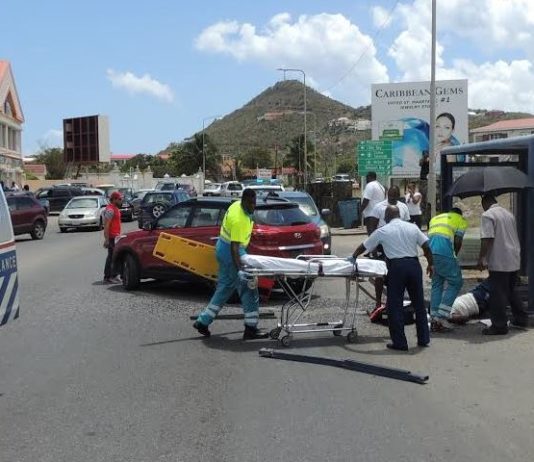 Lady struck by motor vehicle while sitting in the bus stop.