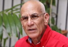 History of the concrete road divider at Maho Beach