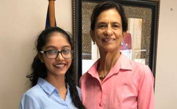 President of Parliament Sarah Wescot presented with reusable canvas bags proposal by Creative Hands.