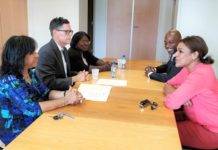 Minister Plenipotentiary and deputy Minister Plenipotentiary sign declaration with Electoral Council