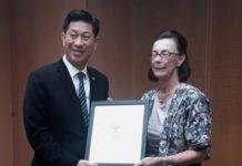 Minister Lee presented with poster in connection with AUCs Community Action Day