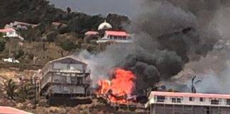 Live video coverage of a large building on fire in Hell’s Gate SABA