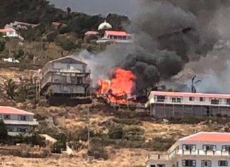 Live video coverage of a large building on fire in Hell’s Gate SABA