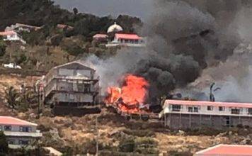 Live video coverage of a large building on fire in Hell’s Gate SABA