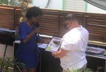 Former Minister Gordon-Carty presents copy of her book to USP Leader Frans Richardson