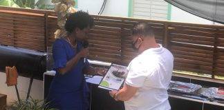 Former Minister Gordon-Carty presents copy of her book to USP Leader Frans Richardson