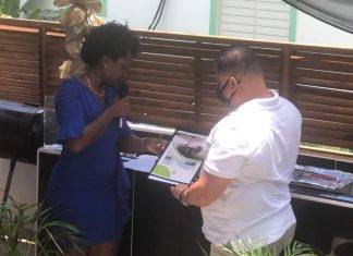 Former Minister Gordon-Carty presents copy of her book to USP Leader Frans Richardson