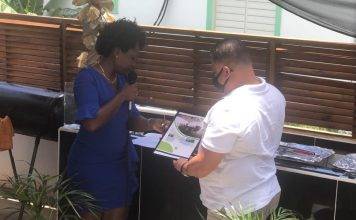 Former Minister Gordon-Carty presents copy of her book to USP Leader Frans Richardson