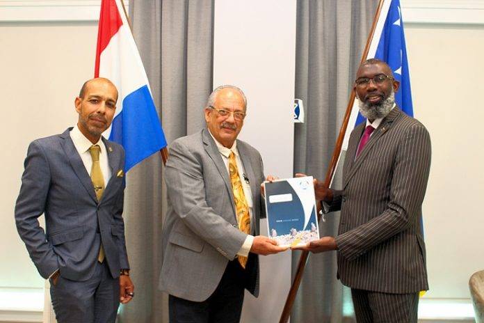 Acting SER President Mr. John Jacobs hands over the first copy of the 2020 Annual Report to Prime Minister the Honorable Mr. Gilmar Pisas in the presence of SER Director and General Secretary Mr. Raul Henriquez