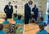 Minister Ottley distributes water and apples in honor of World Oral Health Day to the students of Marie Genevieve DeWeever school
