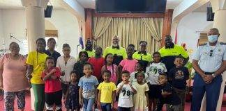 Officers talk about good conduct with summer camp kids
