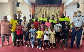 Officers talk about good conduct with summer camp kids