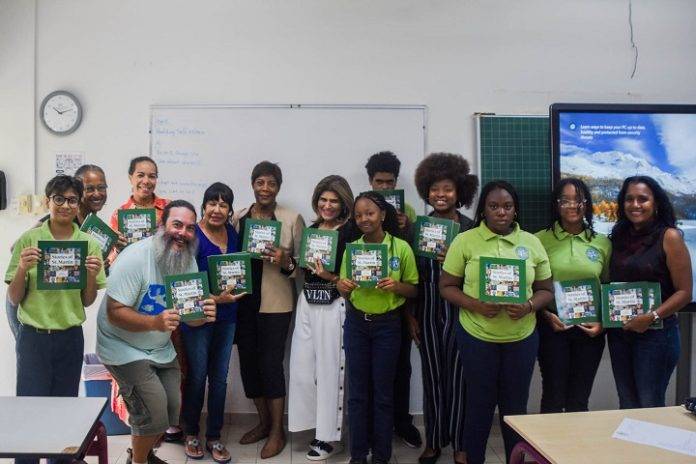Island Gems members Vera Cupen, Asha Stevens, Hanisha Alwani, Milva Hoeve and Ludmilla de Weever with Mark Yokoyama of Association Les Fruits de Mer with St. Dominic High School students and Teacher Marie Richardson.