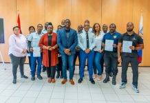 Justice Minister Lyndon Lewis delivers a new batch of 25 National Decrees to Justice Workers.