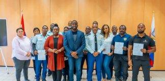 Justice Minister Lyndon Lewis delivers a new batch of 25 National Decrees to Justice Workers.