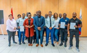 Justice Minister Lyndon Lewis delivers a new batch of 25 National Decrees to Justice Workers.
