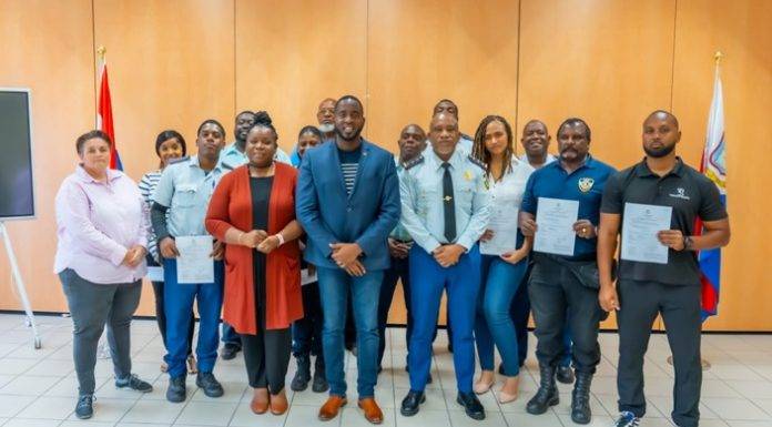 Justice Minister Lyndon Lewis delivers a new batch of 25 National Decrees to Justice Workers.