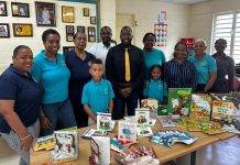 Minister Lewis official presentation of Educational Material to Marie Genevieve de Weever School