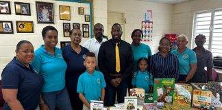 Minister Lewis official presentation of Educational Material to Marie Genevieve de Weever School
