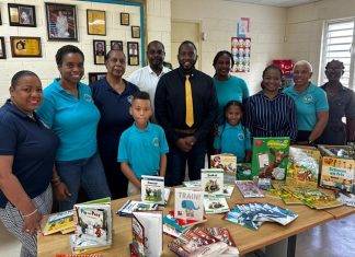 Minister Lewis official presentation of Educational Material to Marie Genevieve de Weever School
