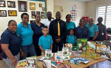 Minister Lewis official presentation of Educational Material to Marie Genevieve de Weever School