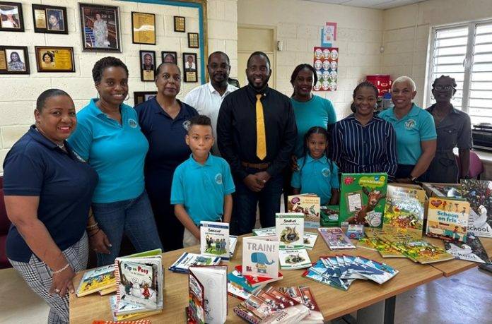 from left to right are first row Ray Carrasco Solomons, Minister Lyndon Lewis, Christelle Brown, Miranda Morris-Carty, Candyta Richardson, Claudia Connor Second row Shemiah Fleming, Merlin Joseph, Sandra Matthew-White, Daison Marks, and Sharisse Daniel
