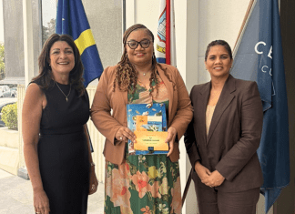 Minister of Finance, Marinka J. Gumbs, Presented with Historical NAf Book and Caribbean Guilder Collector’s Set