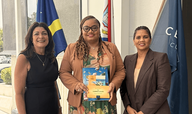 Minister of Finance, Marinka J. Gumbs, Presented with Historical NAf Book and Caribbean Guilder Collector’s Set