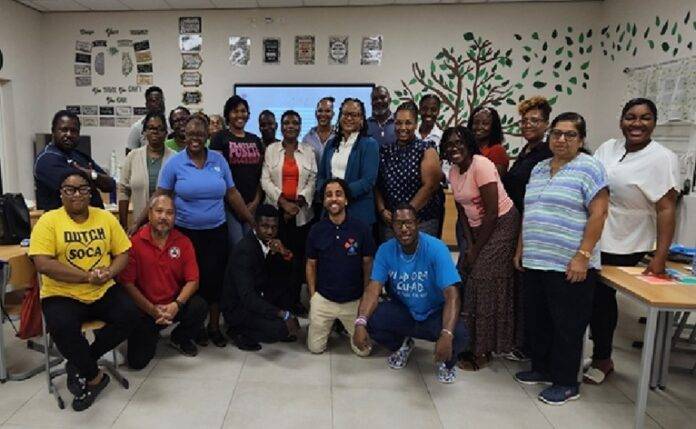 Pictured are SMVTS educators; Dr. Christian Boakye and Mr. Jaine Lindo from FullSTEAM (kneeling); Ms. Oralie Boirad, Acting Division Head, and Project Manager Ms. Lissa Carter of DEI (center); Ms. Marcellia Henry, Secretary General of UNESCO Sint Maarten (far left); Mrs. Erin Ellis-Coram and Ms. Esmeralda Sutton, policy advisors to Minister Gumbs.