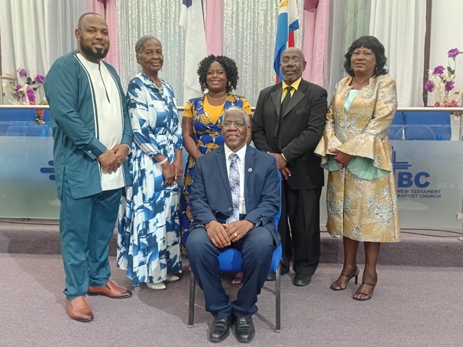 The New National Board of SMUMF seated in centre-foundation president Pastor Isaac Harold Richardson, back row from left to right, public relations officer Rev. Dr. Nolan Nanton, secretary Pastor Rita Edwards, vice president Pastor Torana Granston, treasurer Pastor Nigel Brooks and boardmember Prophet Delphine Agnes Brooks.